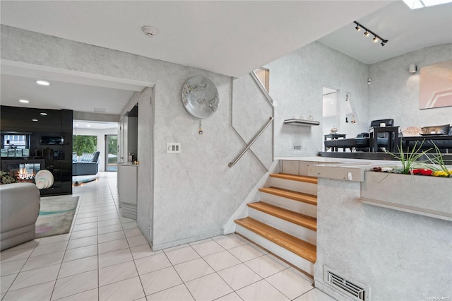 stairs with tile patterned floors