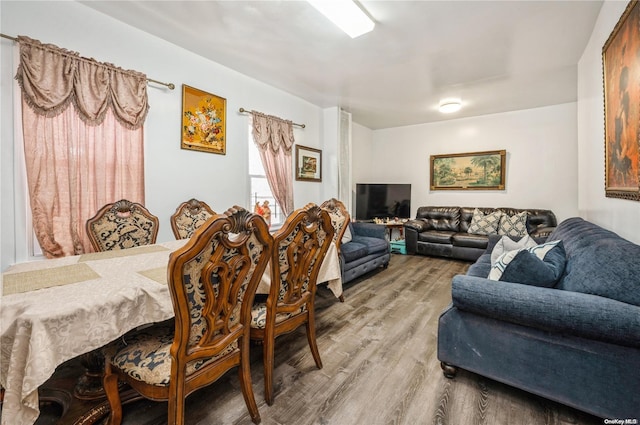 dining space with hardwood / wood-style flooring