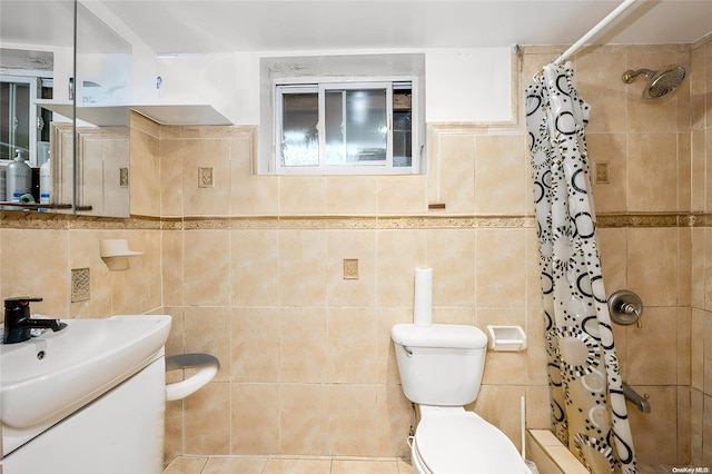 bathroom with toilet, a shower with curtain, tile patterned floors, and tile walls