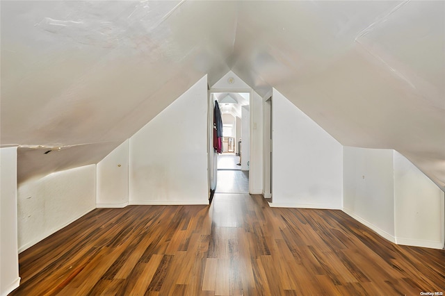 bonus room with dark hardwood / wood-style floors and lofted ceiling