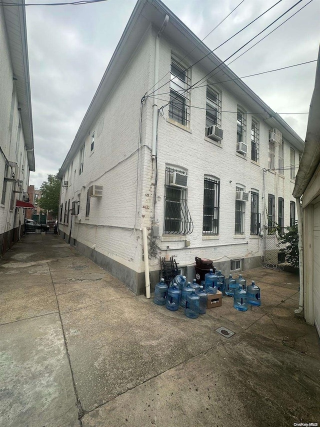 view of property exterior with a wall mounted AC and cooling unit