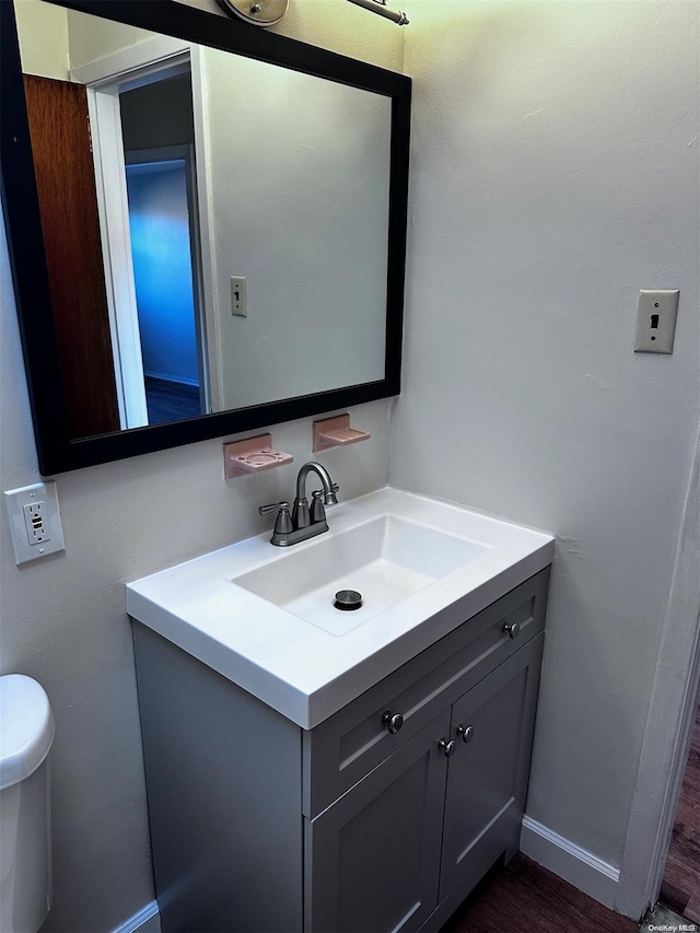 bathroom featuring vanity, toilet, and wood-type flooring