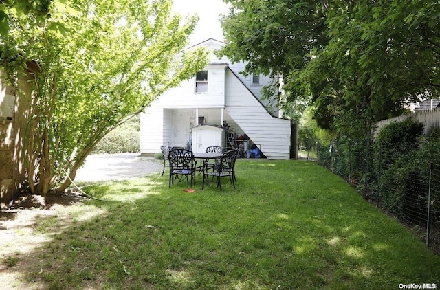 rear view of property with a yard