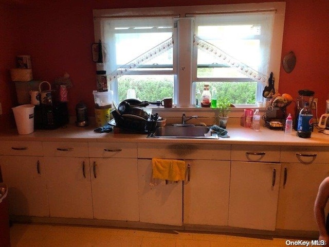 kitchen with light tile patterned flooring and sink