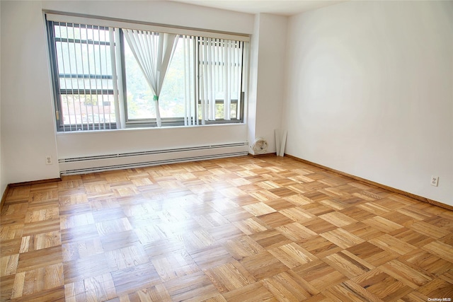 spare room with light parquet flooring and a baseboard radiator