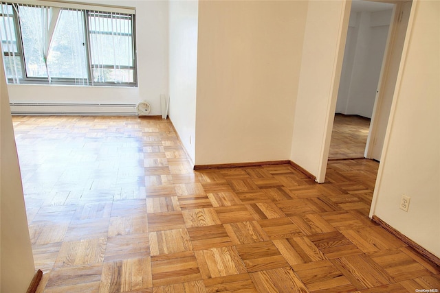 empty room featuring baseboard heating and light parquet floors