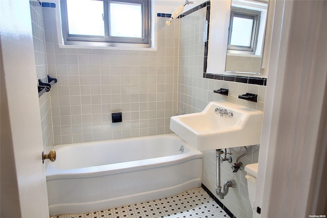 bathroom featuring tile walls and sink