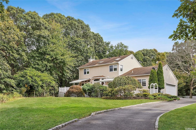 view of property exterior with a garage and a yard