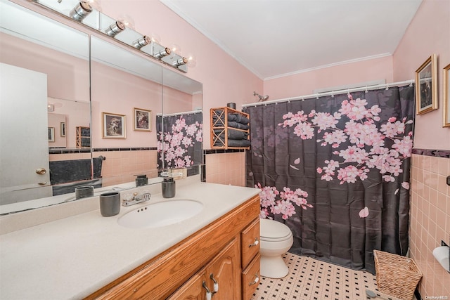 bathroom with tile patterned floors, ornamental molding, vanity, tile walls, and toilet