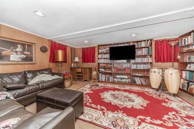 carpeted living room with wooden walls