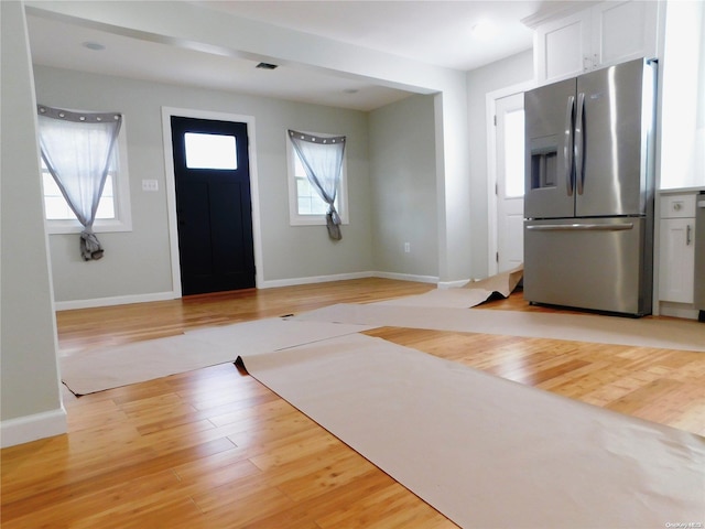 foyer entrance featuring light hardwood / wood-style flooring and a healthy amount of sunlight