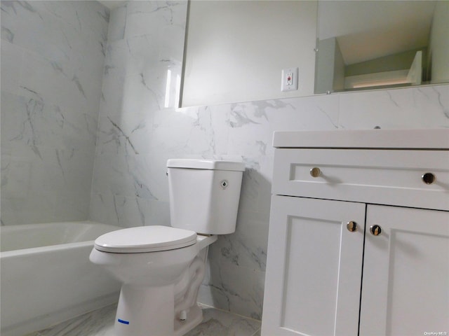 bathroom featuring vanity, toilet, and tile walls