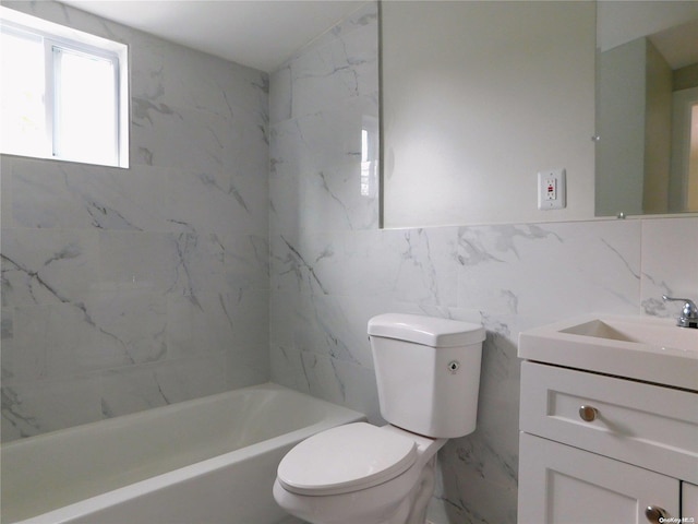 full bathroom with vanity, toilet, tile walls, and tiled shower / bath combo