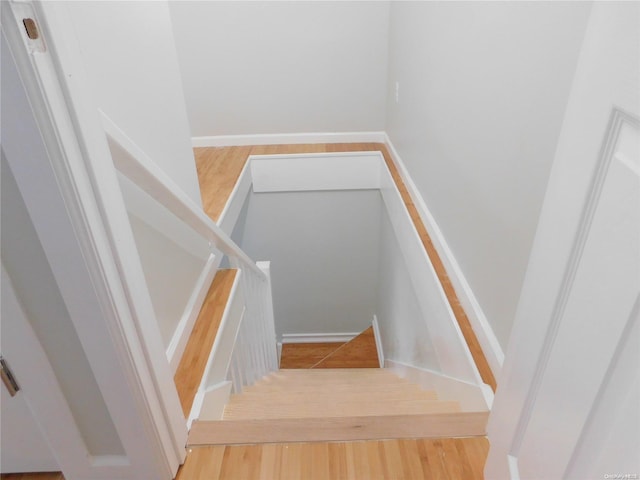 stairs featuring hardwood / wood-style floors