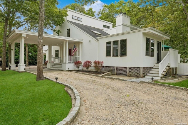 back of house with a porch and a yard