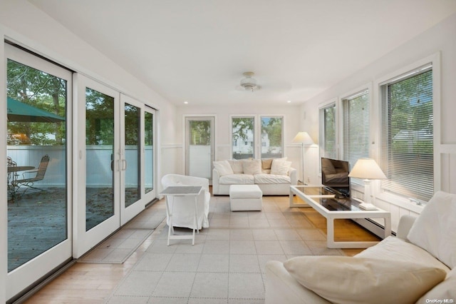 sunroom with french doors, plenty of natural light, and ceiling fan