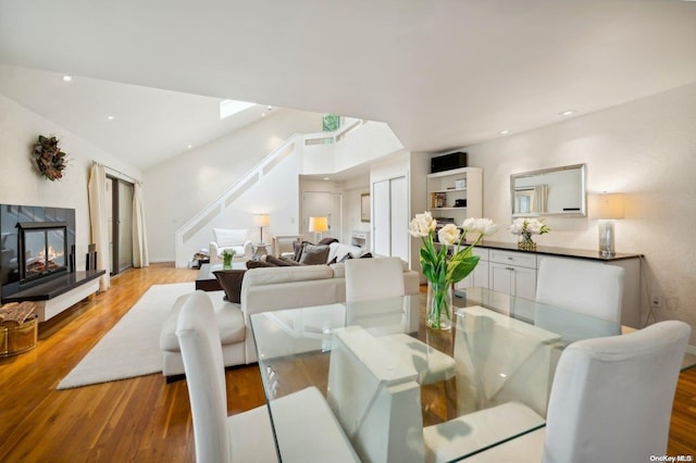 living room featuring light hardwood / wood-style flooring and lofted ceiling