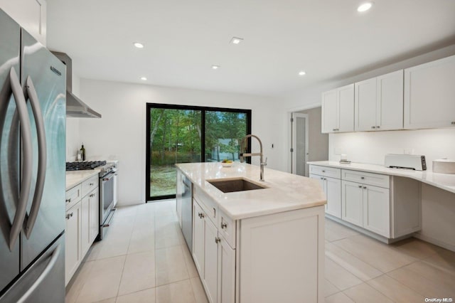 kitchen with a center island with sink, white cabinets, sink, and stainless steel appliances