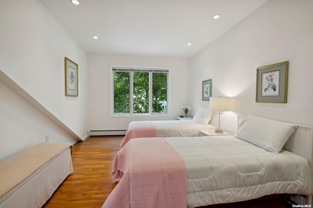 bedroom featuring light hardwood / wood-style floors and baseboard heating