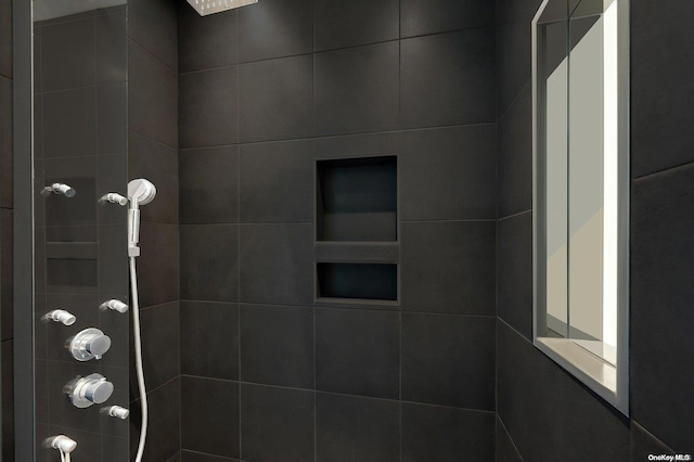 bathroom with a tile shower