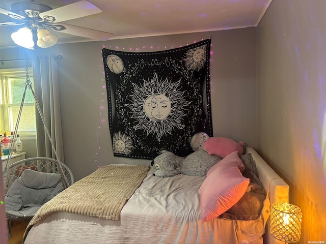 bedroom with ceiling fan and crown molding