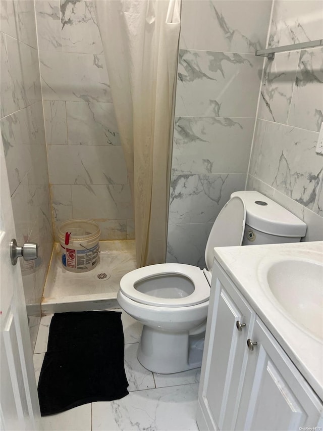 bathroom featuring vanity, curtained shower, toilet, and tile walls