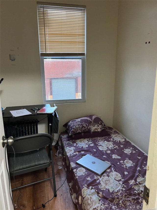 bedroom with hardwood / wood-style floors