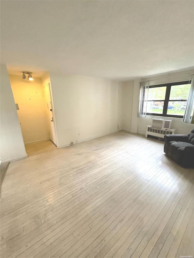 unfurnished living room featuring light hardwood / wood-style floors