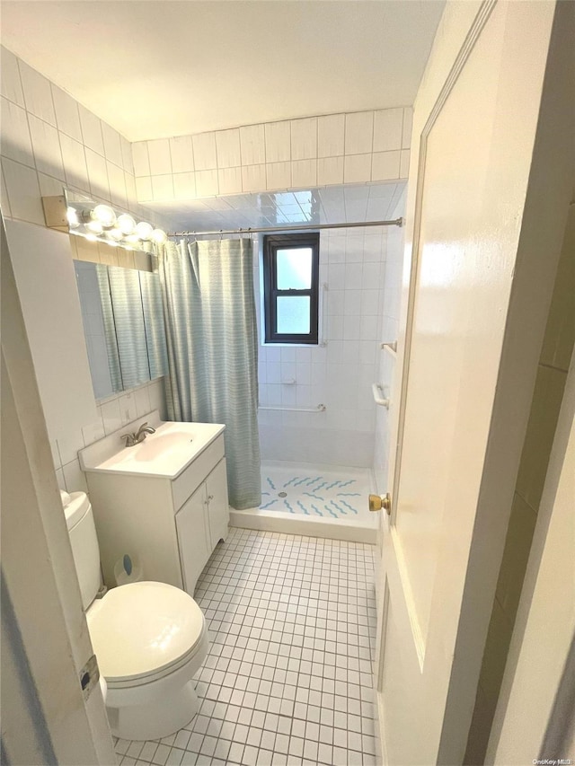 bathroom featuring tile patterned flooring, a shower with curtain, toilet, and vanity