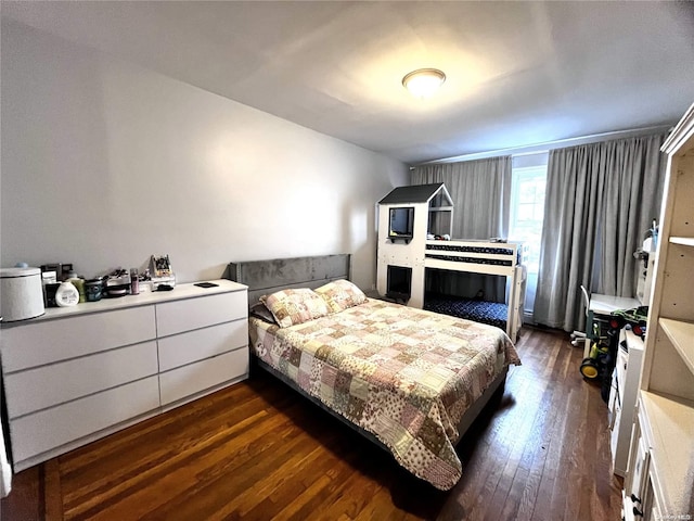 bedroom with dark hardwood / wood-style flooring