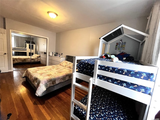 bedroom with dark hardwood / wood-style floors and a closet