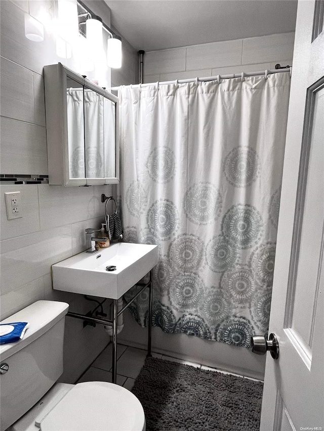 full bathroom with sink, tile patterned flooring, toilet, shower / tub combo with curtain, and tile walls