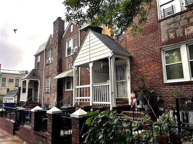 view of front of home with cooling unit and brick siding