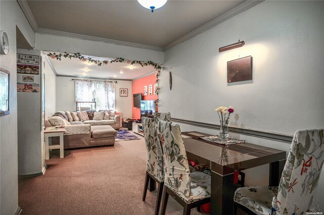 carpeted dining area with ornamental molding