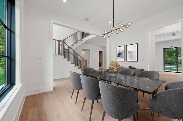 dining space featuring a chandelier and light hardwood / wood-style floors