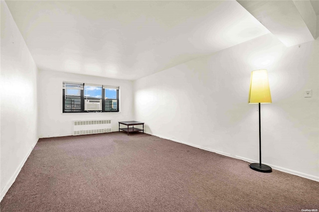 carpeted empty room with radiator heating unit