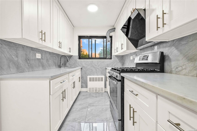 kitchen featuring backsplash, white cabinetry, stainless steel range with gas cooktop, and sink