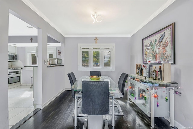 dining room featuring dark hardwood / wood-style floors and ornamental molding