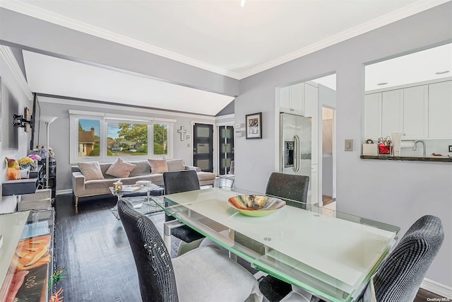 dining room with sink, hardwood / wood-style floors, and ornamental molding