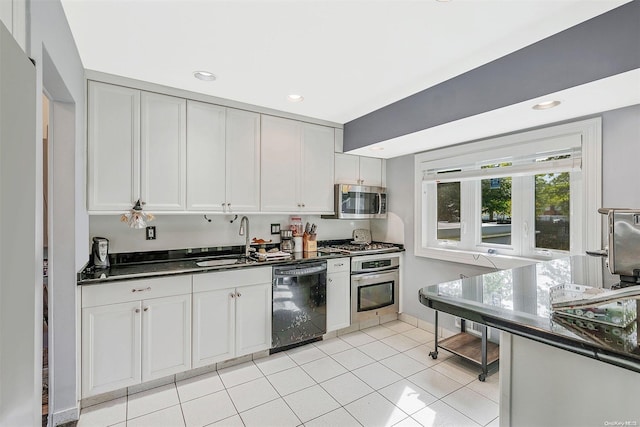 kitchen with white cabinets, light tile patterned floors, stainless steel appliances, and sink