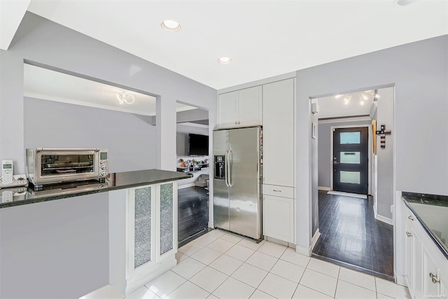 kitchen with white cabinets, stainless steel refrigerator with ice dispenser, light hardwood / wood-style floors, and crown molding