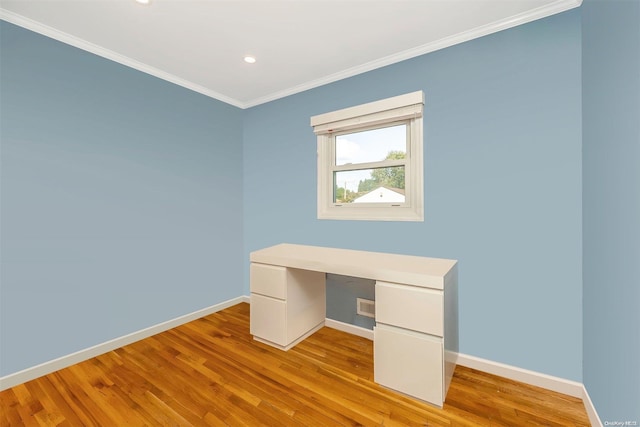 unfurnished office with crown molding and light hardwood / wood-style flooring