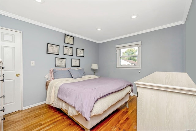 bedroom with wood-type flooring and ornamental molding