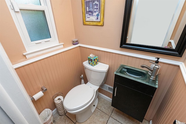 bathroom with tile patterned flooring, vanity, and toilet