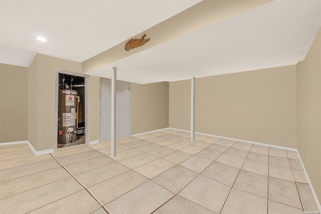 basement with water heater and light tile patterned floors