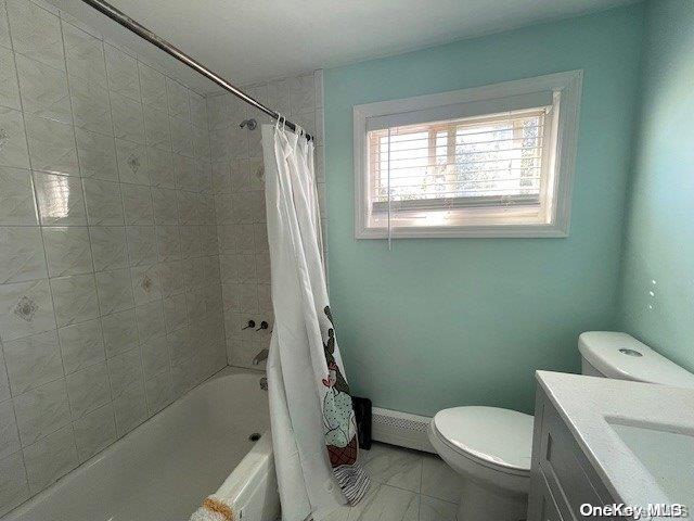 full bathroom featuring vanity, toilet, shower / bath combo with shower curtain, and a baseboard radiator