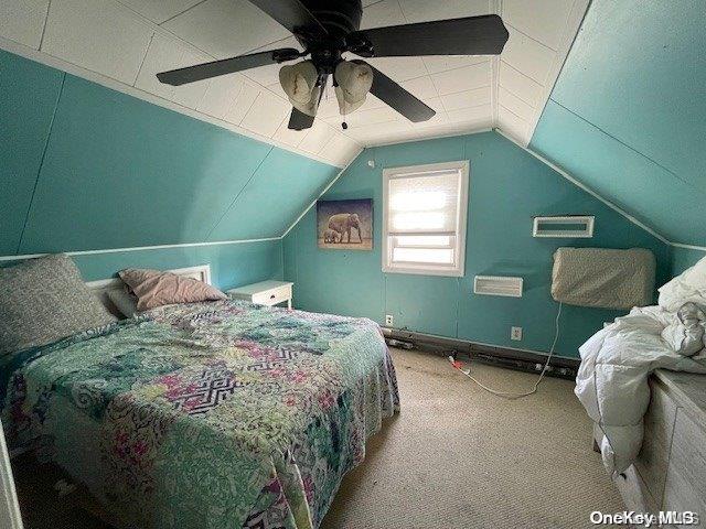 carpeted bedroom featuring ceiling fan and lofted ceiling