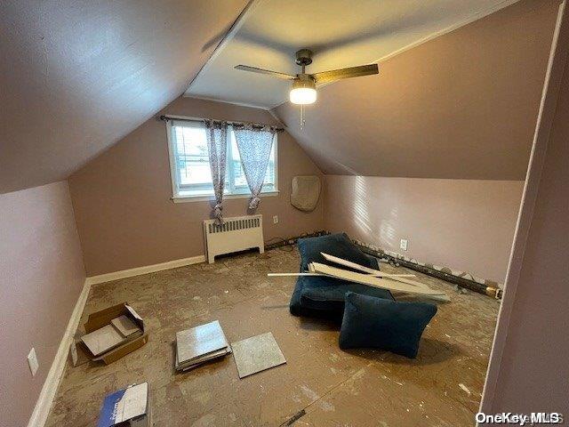 bonus room with ceiling fan, radiator heating unit, and lofted ceiling