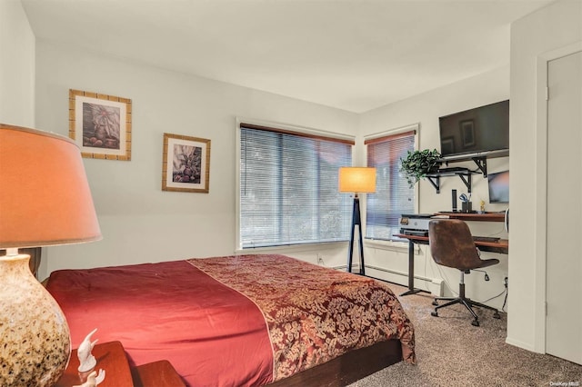 carpeted bedroom with a baseboard heating unit