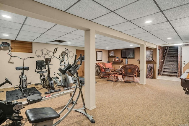 exercise area featuring carpet and a drop ceiling